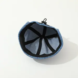 Internal view of denim brimless docker hat featuring black trim and adjustable drawstring