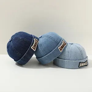 Detail view of denim skull caps in three blue shades with ANGELS patch embroidery