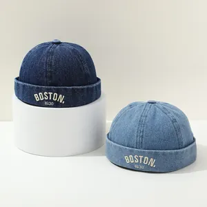 Close-up of blue denim docker hats with white Boston 1630 embroidery for kids