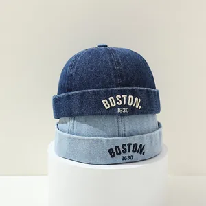 Detail of Boston 1630 letter embroidery on denim docker hats in blue and light blue