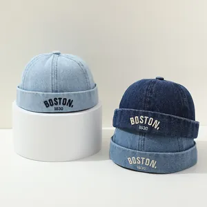 Close-up of denim miki hats with Boston embroidery in light and dark blue shades