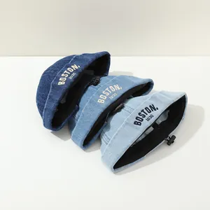 Detail of denim miki hats with Boston embroidery and adjustable drawstring cord