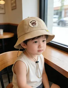 Detail of adjustable windproof drawstring and Happy Bear patch on children sun hat
