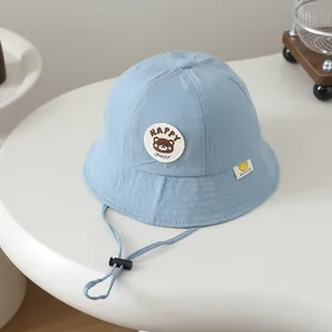 Light blue cotton toddler bucket hat featuring HAPPY Bear embroidery and adjustable chin strap
