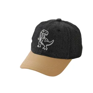Denim kids baseball cap with dinosaur embroidery and contrast tan brim on black base