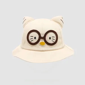 Detail of beige cotton kids sun hat featuring cute cat ears and decorative round glasses