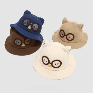 Detailed view of kids cotton bucket hats with cat ears and embroidered cat glasses