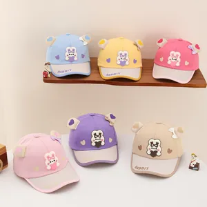 Detailed display of five colorful cartoon rabbit baseball hats for kids with 3D ears