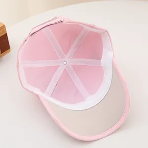 Detail view of pink baby baseball cap interior with white sweatband and adjustable strap