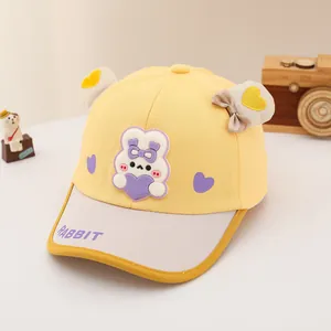 Detail of yellow cotton baby baseball cap with 3D rabbit patch and rabbit text on brim
