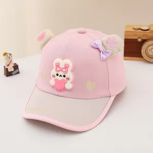 Close-up of pink baby baseball cap with 3D bunny ears and heart motif details