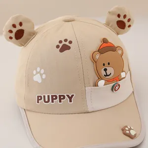 Detail of khaki kids baseball cap with plush ears and 3D cartoon bear pocket design