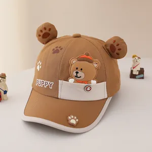 Detail of child baseball cap with plush bear ears, puppy print and decorative pocket