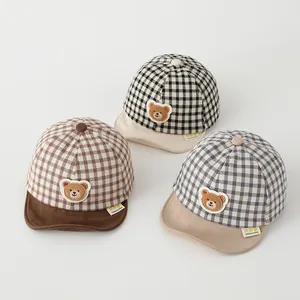 Close-up of soft cotton plaid baby baseball hats with cute plush bear patches