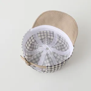 Detailed view of baby cap interior lining and adjustable metal buckle back strap