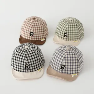 Close-up of baby plaid baseball caps in four colors with embroidered letter R patch