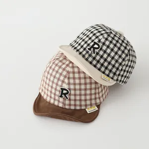 Detail of baby soft brim baseball hats with plaid pattern and embroidered letter R
