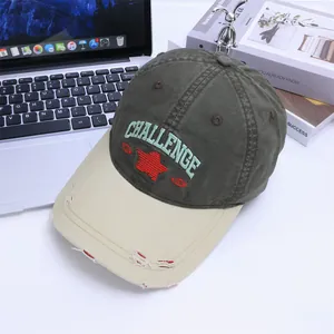 Detail of vintage baseball cap with Challenge embroidery and distressed brim on table