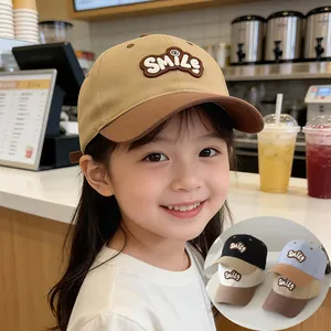 Detailed view of color-block kids baseball cap with Smile patch and various color options