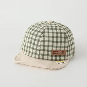 Cute green checkered baby baseball cap with soft brim and adorable bear leather patch