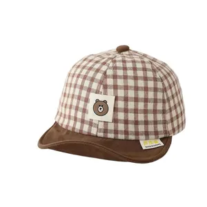 Classic checkered baby baseball cap with cute bear patch and soft brim for spring comfort