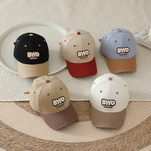 Detailed view of color-block kids baseball caps with BYYO NICEDAY embroidered patches