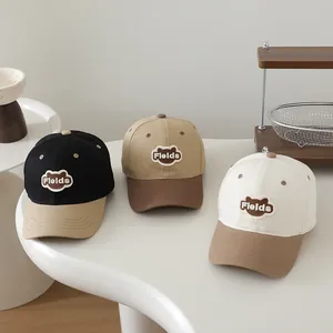 Detailed embroidery of Fields logo and bear motif on cotton patchwork baseball caps