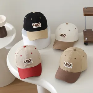 Detail shot of color-blocked kids' baseball caps with LDO SURPRISE embroidery patches