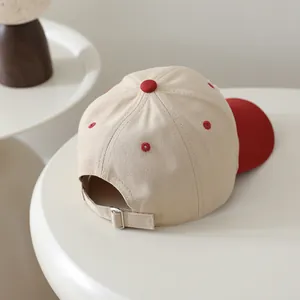 Close-up of kids baseball cap showing metal adjustable buckle and cotton twill fabric texture