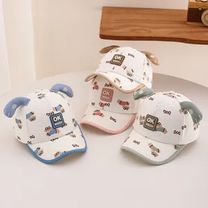 Detailed view of three toddler baseball caps with 3D ears and cartoon dog patterns