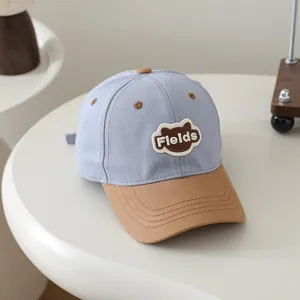 Kids baseball cap with brown bear patch and Fields text in blue and brown