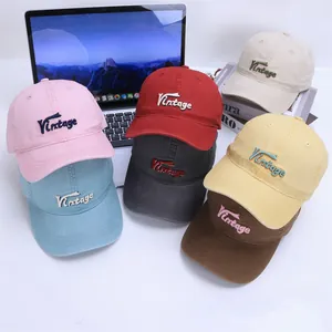 Close-up of vintage embroidered kids' cotton baseball caps in multiple colors