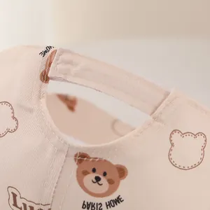 Close-up of adjustable velcro strap and cute bear pattern on toddler sun hat