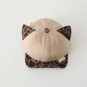 Detail view of cotton baby baseball cap with leopard print brim and 3D cat ears