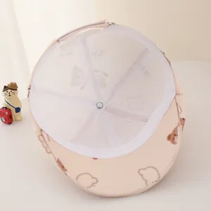 Detail of baby beige cap interior showing breathable mesh lining and bear patterns