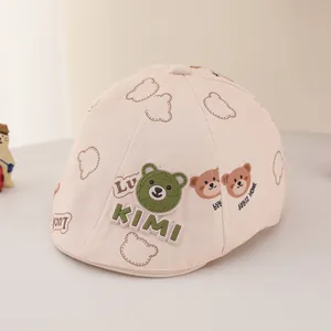 Detail of beige baby flat cap with cute bear prints and green 3D KIMI bear badge
