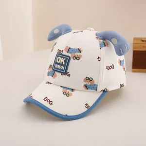 Detail of cream toddler baseball cap with blue brim and 3D dog ears and OK patch