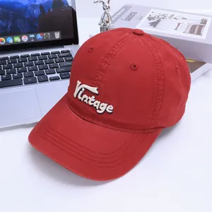 Macro detail of high-quality vintage 3D embroidery on a red cotton baseball cap