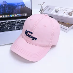 Detail of vintage embroidery and stitching on a pink cotton kids baseball cap