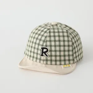 Infant soft brim baseball cap with green checkered pattern and embroidered R letter