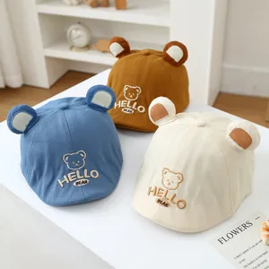 Detailed embroidery of bear face and HELLO BEAR text on toddler baseball caps in multi-colors