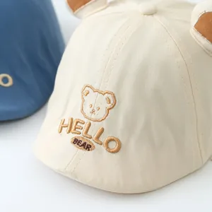 Detailed close-up of baby beige cotton beret with bear embroidery and 3D ears