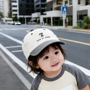 Detail of embroidered number seven and gray brim on a cream kids baseball cap