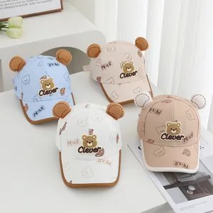 Detail of four colorful baby baseball caps featuring cute 3D bear ears and animal prints