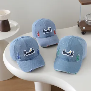 Detail of distressed denim baseball caps with colorful stitching and break patch embroidery