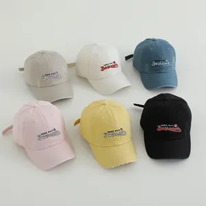Flat lay of six distressed baseball caps in various colors with embroidery detail
