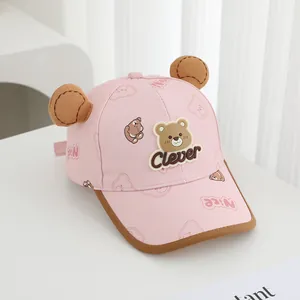 Detailed view of pink toddler baseball cap with cute brown bear ears and clever patch