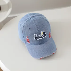 Detail showing distressed denim fabric and embroidered patch on kids baseball cap