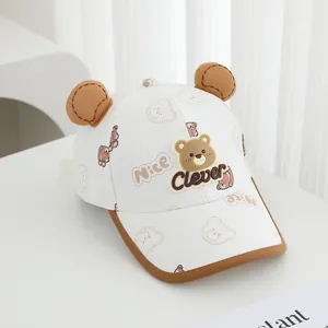 Close-up of white baby baseball cap with cute brown bear ears and Clever silicone patch