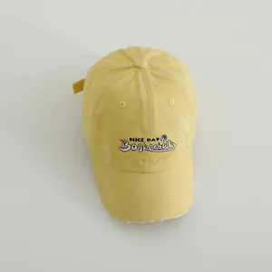 Distressed mustard yellow cotton baseball cap with 'NICE DAY' embroidery in street style